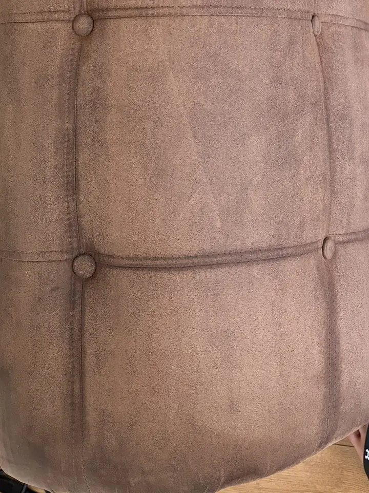 The same sofa arm after cleaning, with the dark patch lifted